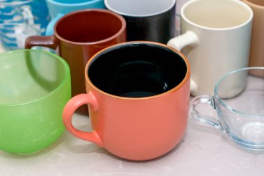 Masanın üzerinde farklı şekil ve boyutlarda boş kupalar