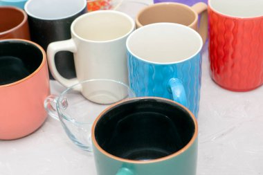 Masanın üzerinde farklı şekil ve boyutlarda boş kupalar