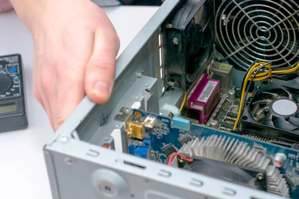 the master repairs an old dusty computer. High quality photo