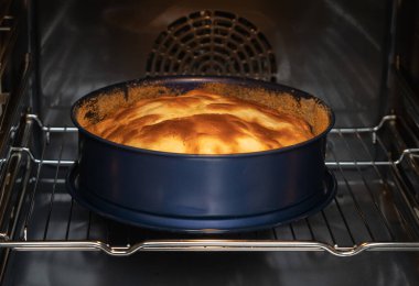 Round apple pie in an oven
