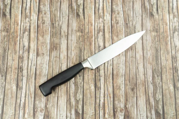 Butchers knife on wooden background