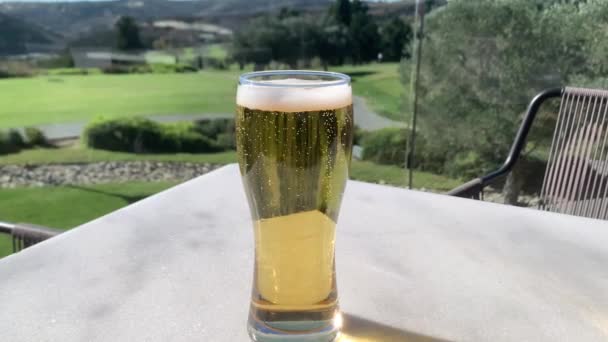 Холодное светлое пиво в стакане с каплями воды и пузырьками. Пиво близко. 4K — стоковое видео