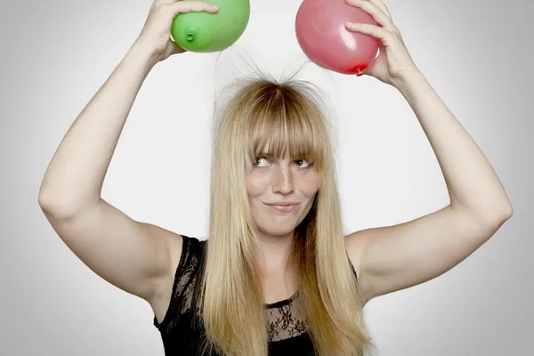 Young beautiful blond haired girl with electric loaded balloons — Stock Photo, Image