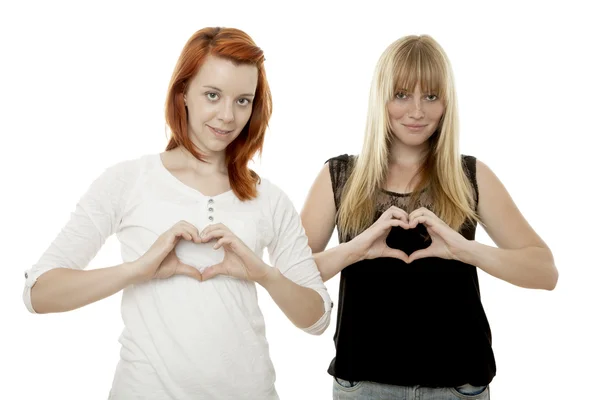 Young beautiful red and blond haired girlssinging hearts — Stock Photo, Image