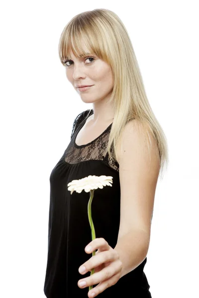 Young beautiful blond haired girl gives you a flower — Stock Photo, Image