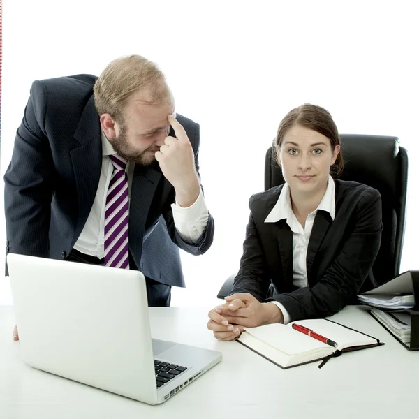 Beard business man brunette woman at desk think employee is stupid Stock Photo