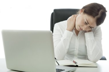young brunette business woman has pain neck behind computer clipart