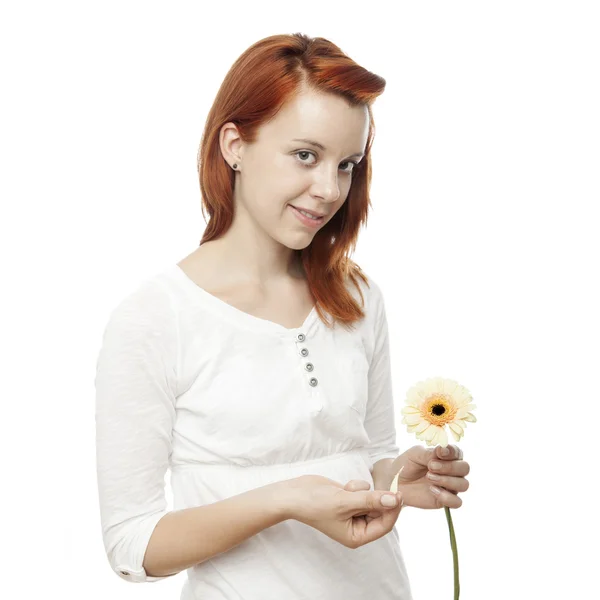 Young beautiful red haired girl is playing he loves me — Stock Photo, Image