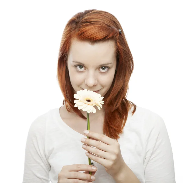 Young beautiful red haired girl smelling on a flower — Stock Photo, Image