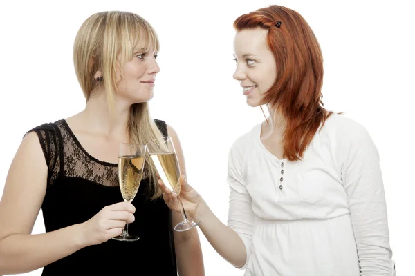 Young beautiful red and blond haired girls with two glass champagne — Stock Photo, Image