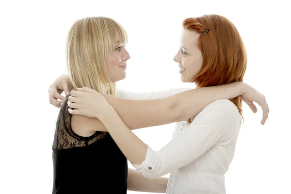 Young beautiful red and blond haired girls are happy together Stock Photo