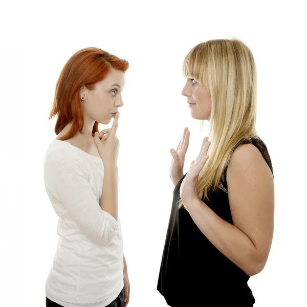 Young beautiful red and blond haired girls finger on mouth — Stock Photo, Image
