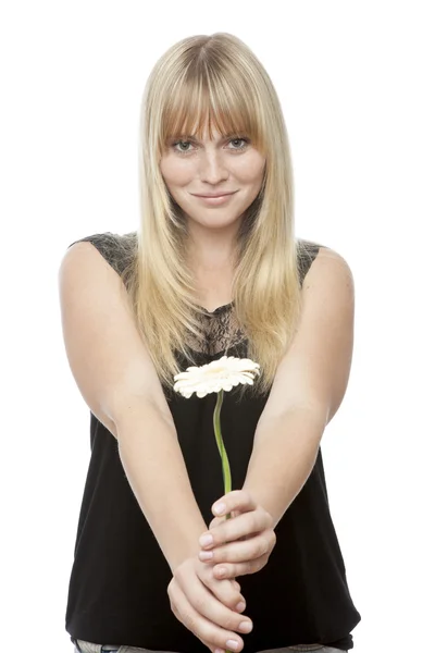 Young beautiful blond haired girl gives you a flower — Stock Photo, Image