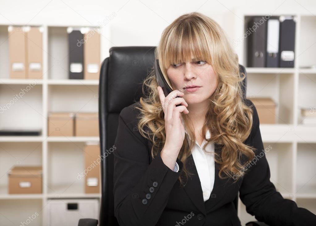 Pretty businesswoman listening to a phone call