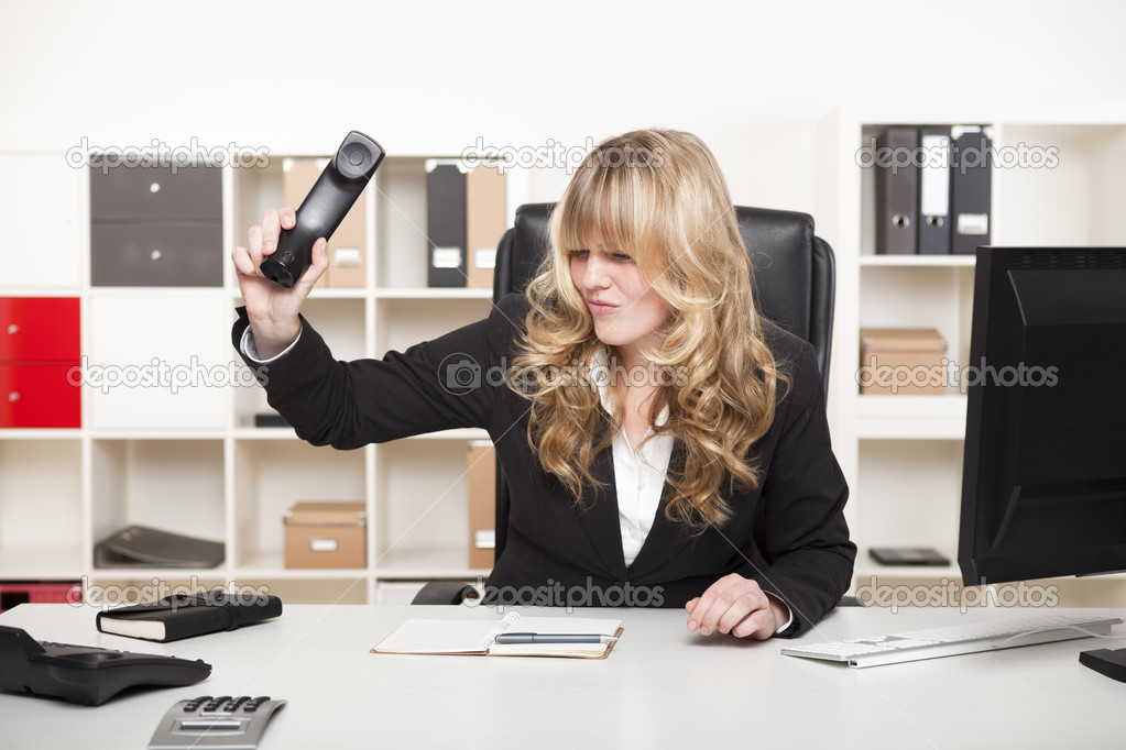 Businesswoman slamming down the phone