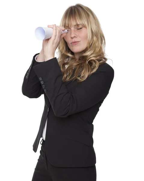 Businesswoman looking through a paper tube — Stock Photo, Image