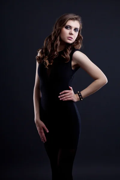 Portrait of beautiful brunette over dark background — Stock Photo, Image