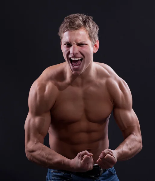 Muscle sexy naked young man show his strength — Stock Photo, Image