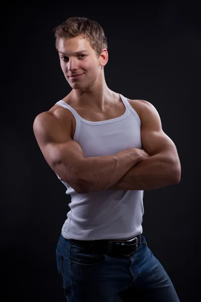 Sexy young man wearing white undershirt and jeans — Stock Photo, Image