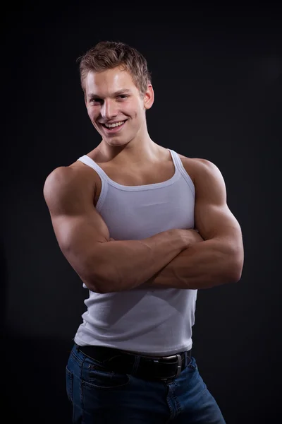 Sexy young man wearing white undershirt and jeans — Stock Photo, Image