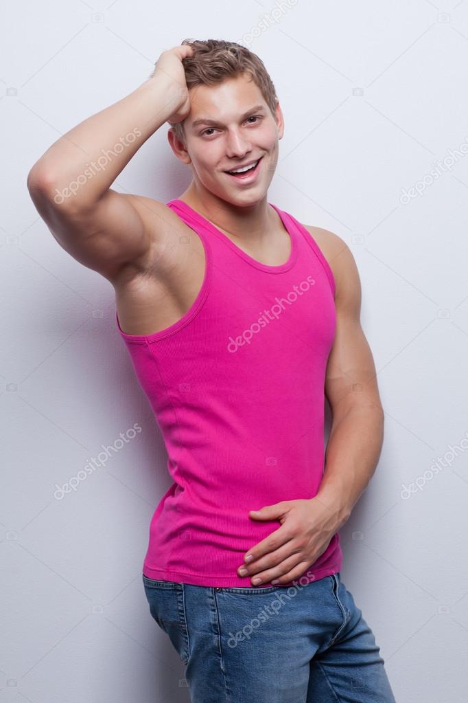 Sexy young man wearing undershirt and jeans