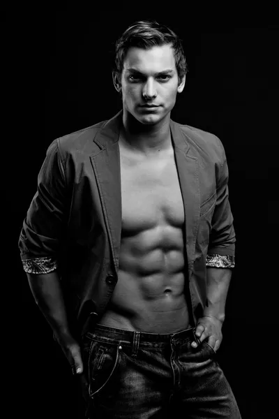 Black and white portrait of sexy man with open jacket over dark — Stock Photo, Image