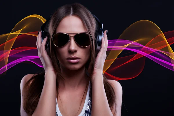 Woman DJ enjoying the music in the headphones — Stock Photo, Image