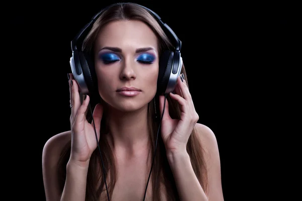 Young DJ woman enjoying the music in the headphones — Stock Photo, Image