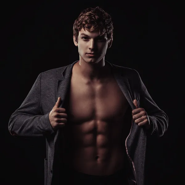 Young handsome macho man with muscle abdominal and open jacket — Stock Photo, Image