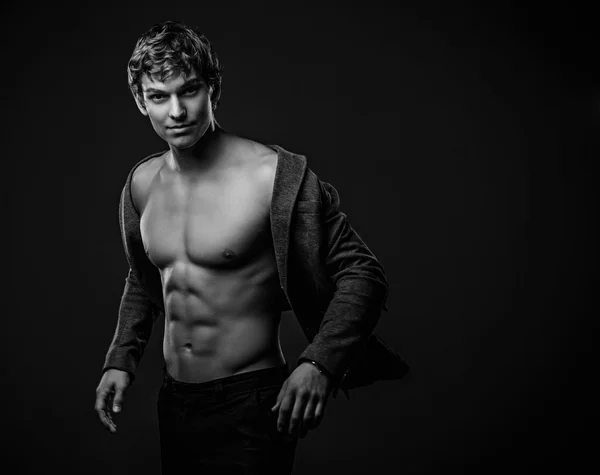 Young handsome macho man with muscle abdominal and open jacket — Stock Photo, Image