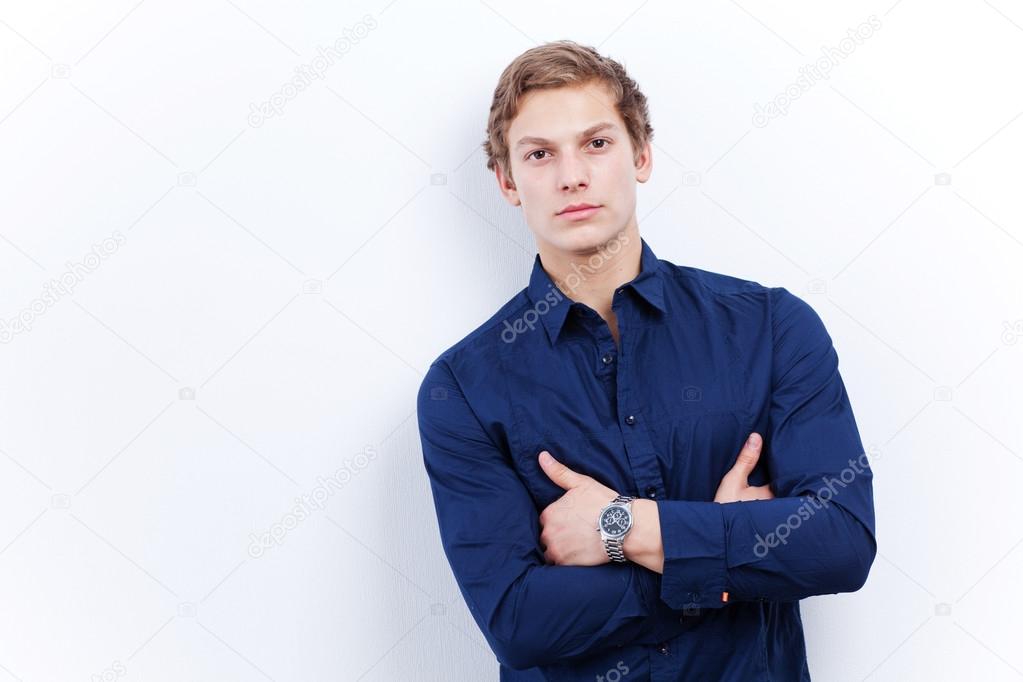 Portrait of a young handsome man wearing blue shirt
