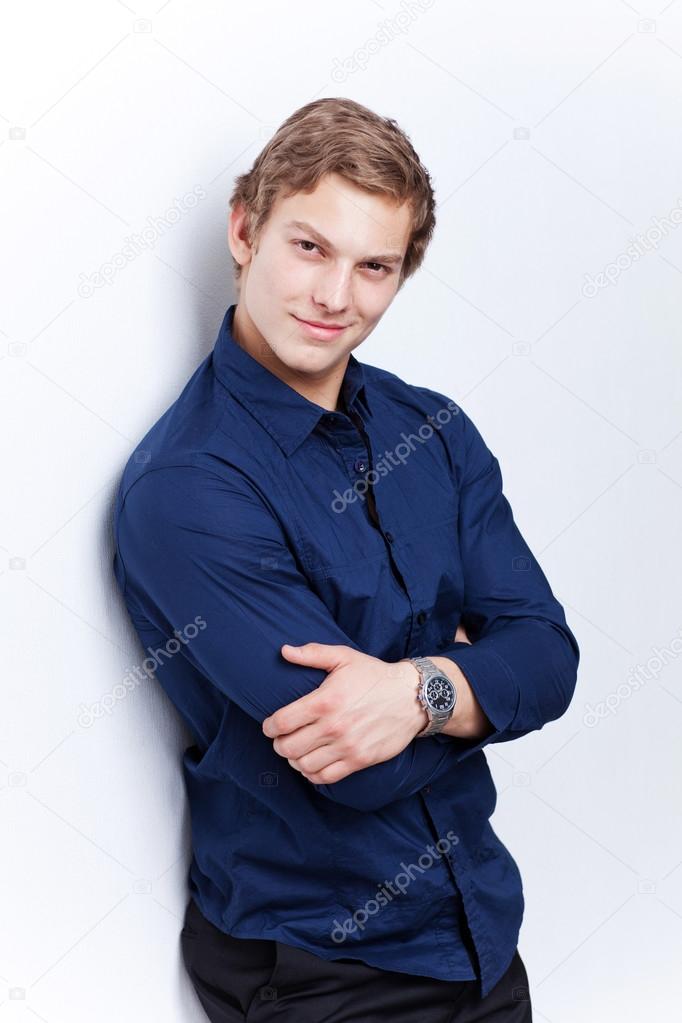 Portrait of a young handsome man wearing blue shirt isolated on