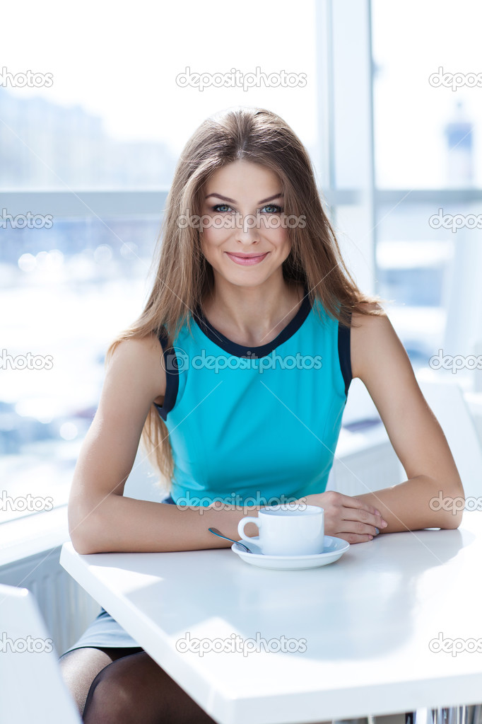 Portrait of a beauty young woman with a tea cup