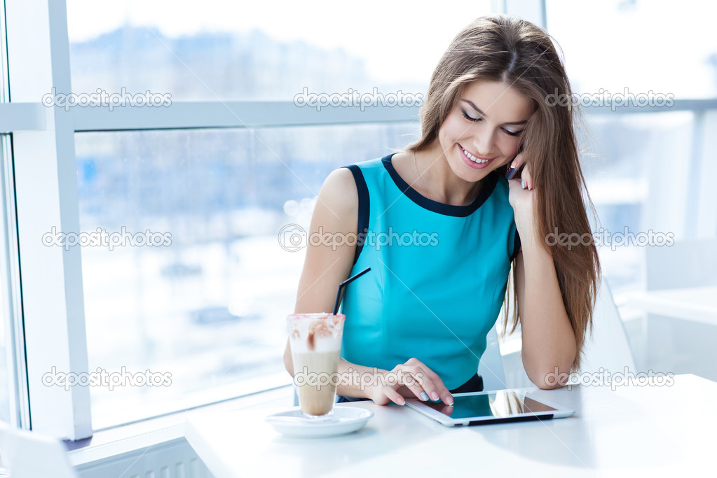 woman talking on the cell phone and using tablet computer