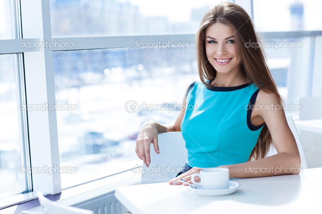 Portrait of a beauty young woman with a tea cup
