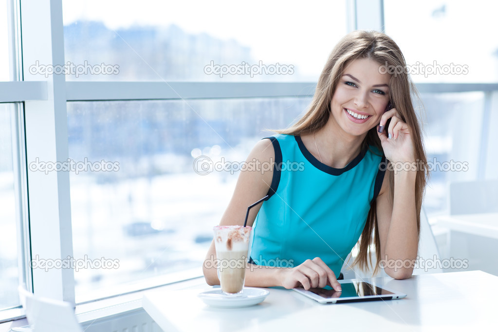 woman talking on the cell phone and using tablet computer