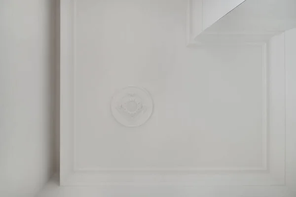 Detail of corner ceiling cornice with intricate crown molding.