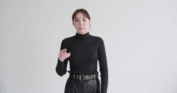 Young Girl Black Clothes White Background Waving Her Hands Shows — Stock Video