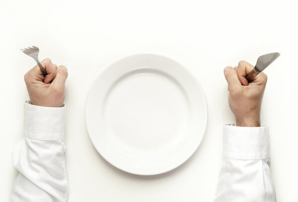 Man holding fork and knife waiting for food isolated on white