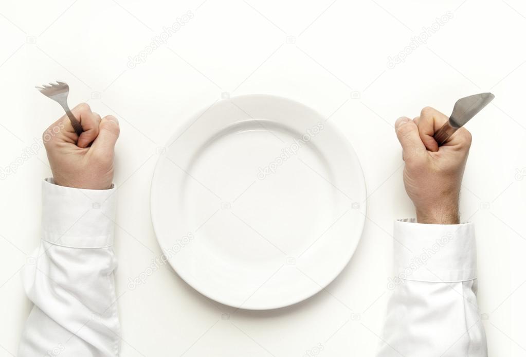 Man holding fork and knife waiting for food isolated on white