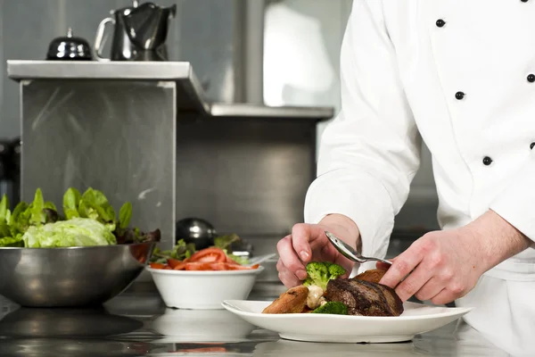 Chef preparing meal (steak with croquette) — Stock Photo, Image