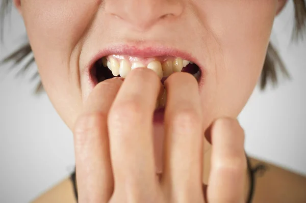 Angst. Close-up van een verwarde jonge vrouw nagels te bijten. — Stockfoto