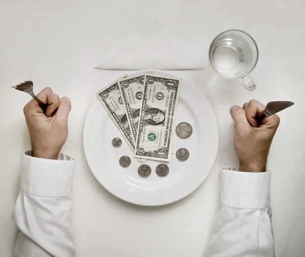 Money diet concept. Man holds fork and knife. Dollar bills and c — Stock Photo, Image