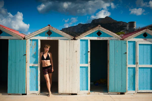 classic beach cabins with a beautiful girl in swimming dres