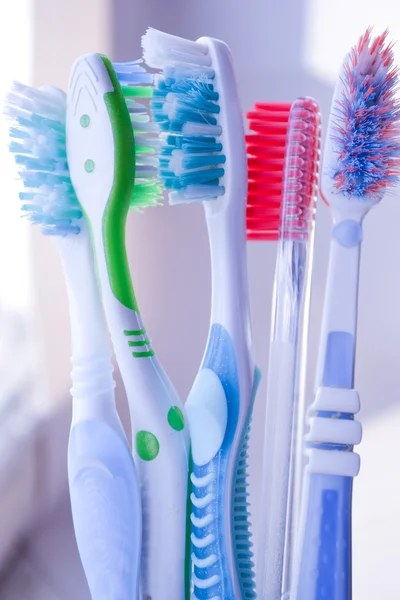 Toothbrushes in glass on white — Stock Photo, Image
