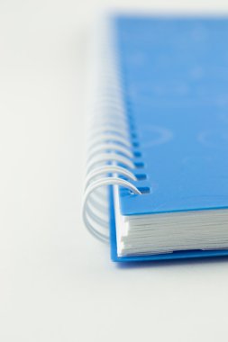 telli defter kitap ya da mavi defter üzerinde beyaz izole yığını