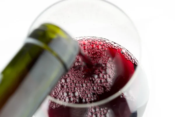 Red wine being poured into a glass — Stock Photo, Image