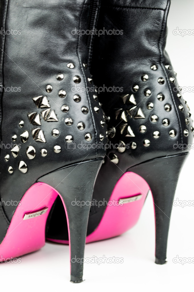 Female high boots with spikes isolated on white
