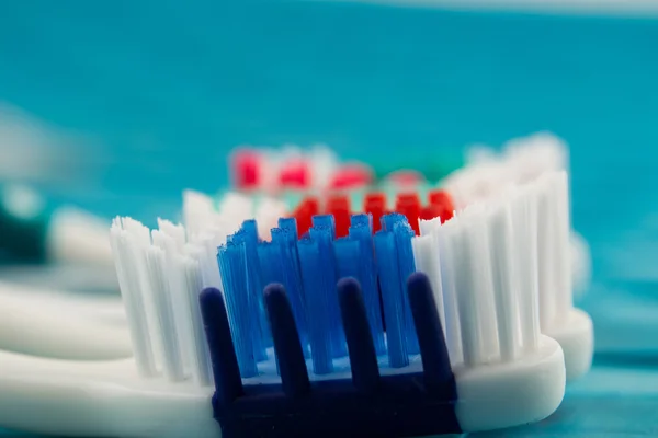 Kleurrijke tandenborstels geïsoleerd op blauwe achtergrond — Stockfoto