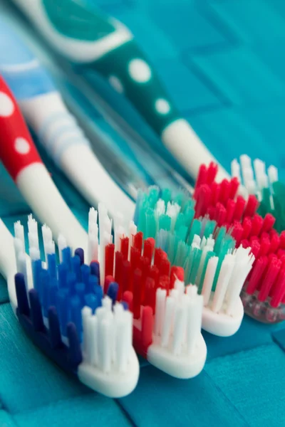 Colorful toothbrushes isolated on blue background — Stock Photo, Image